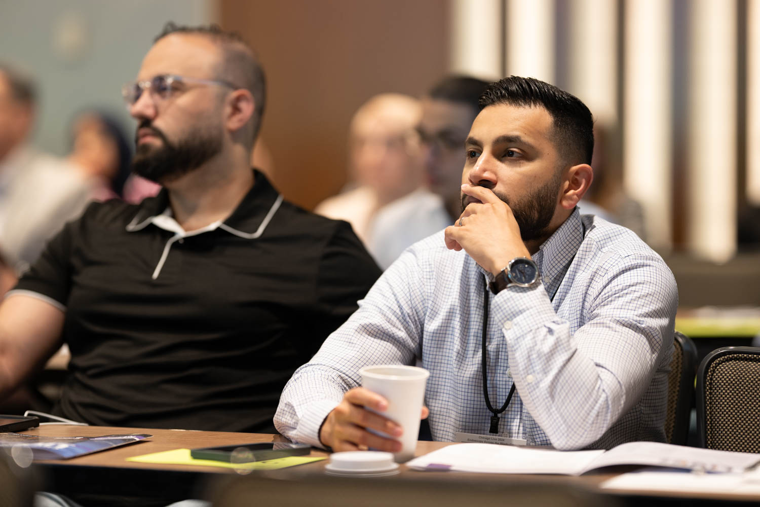 Conference attendee listening to program